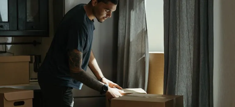 A man packing for moving during Thanksgiving in the DMV area