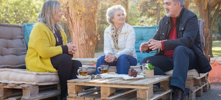 Three seniors sitting outside