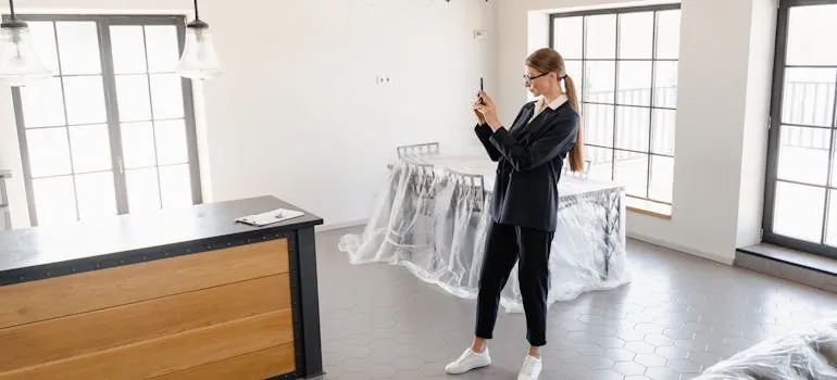 A woman taking photo of the apartment