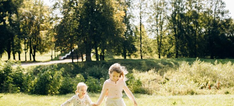 Two kids running in the park