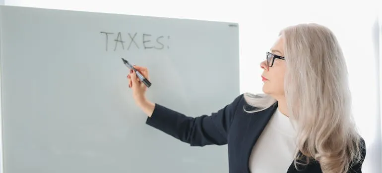 A senior woman writing on the board