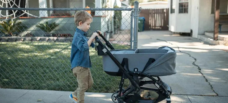 A kid pushing a stroller