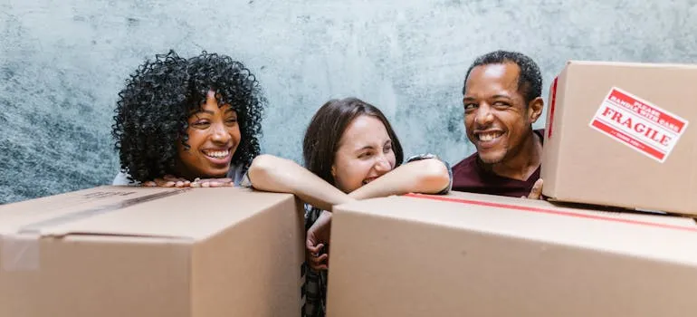 Three people relocating by using the checklist for moving interstate from Virginia