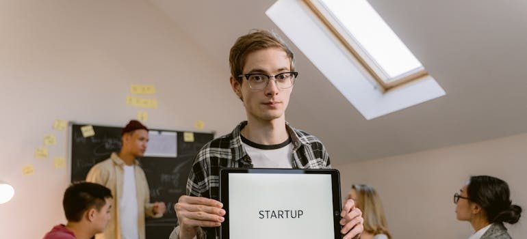 A person holding a startup sign