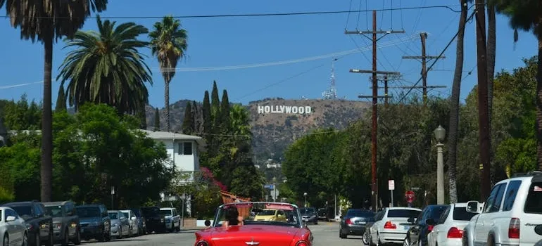 A person driving a car thinking about living in DC vs Los Angeles