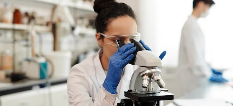 A woman using a microscope 