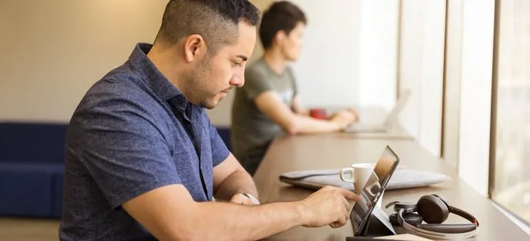 Two people using laptop to research the benefits for remote workers moving from Maryland to Florida