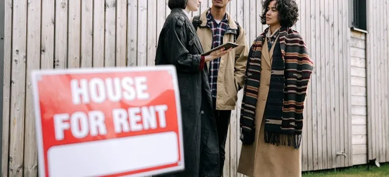 A couple talkikng with the real estate agent about the cost of living differences between Maryland and Pennsylvania