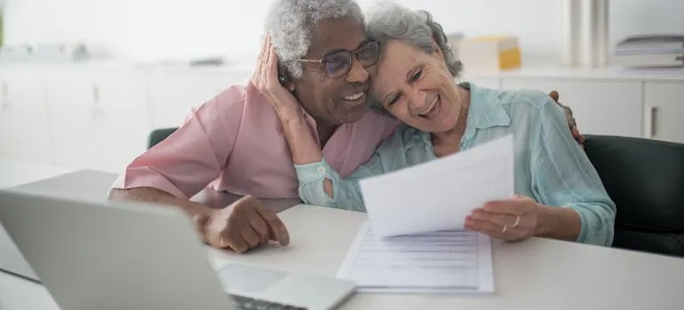 A senior couple holding a document