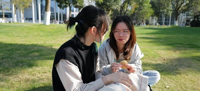 Two women in the park talking about Virginia suburbs vs the city