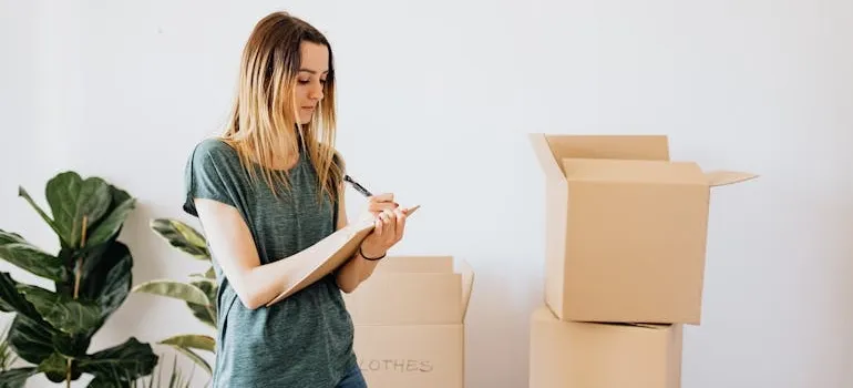 A woman writting a DC to Austin moving guide