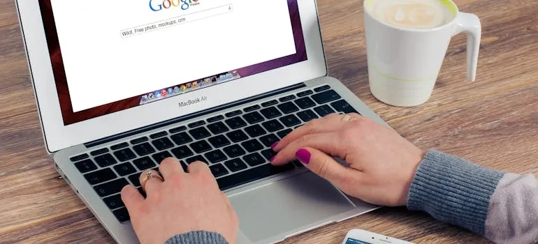 A person using a laptop to find out how storage units help during home renovations
