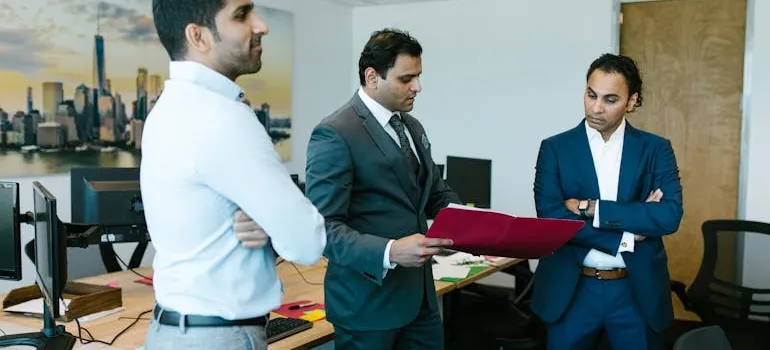 People in the office talking about industries to work in after moving from DC to NYC