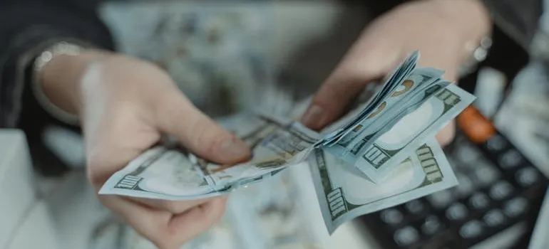 A person counting dollar bills