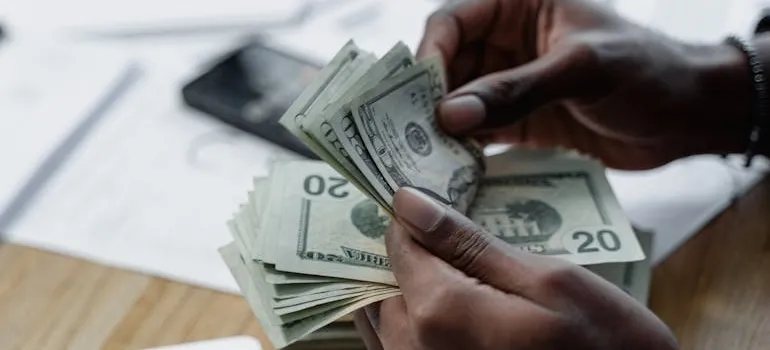 A person counting dollar bills