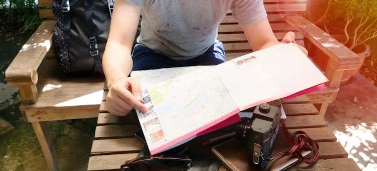 A person holding a book and enjoying outdoor living in Virginia