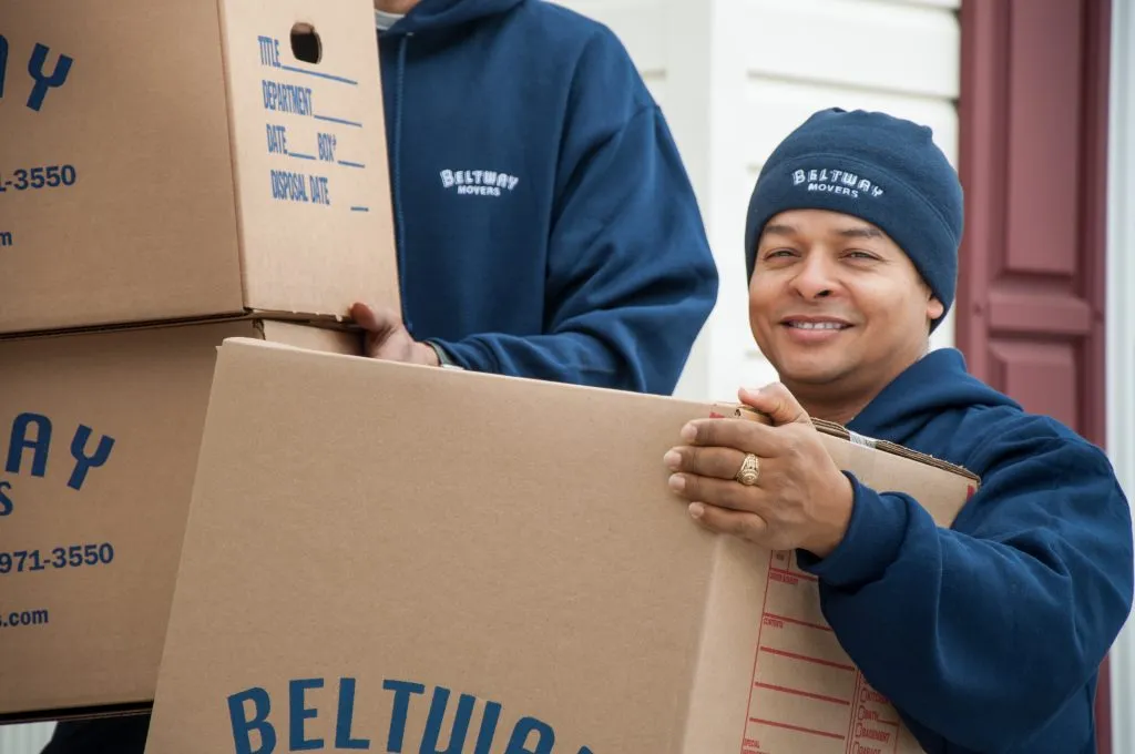 movers holding boxes