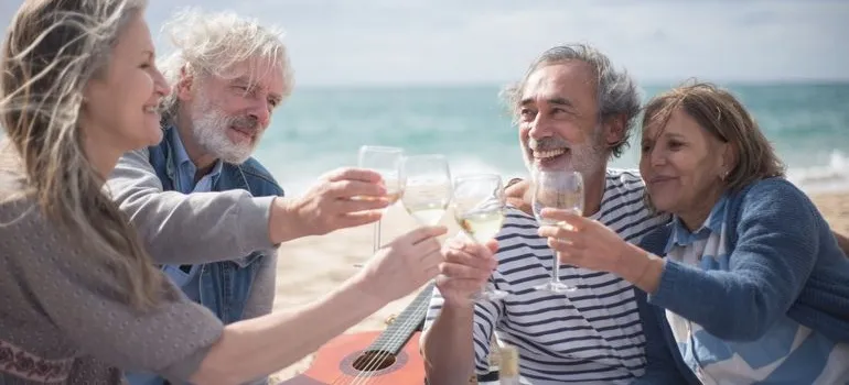 Four people on the beach after retiring from DC to Miami