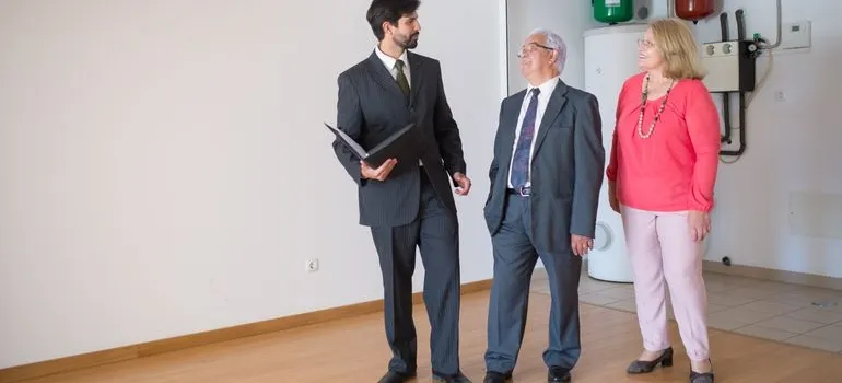 A senior couple talking with a real estate agent