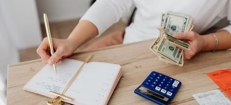 A person calculating the cost of moving from Maryland to California for work