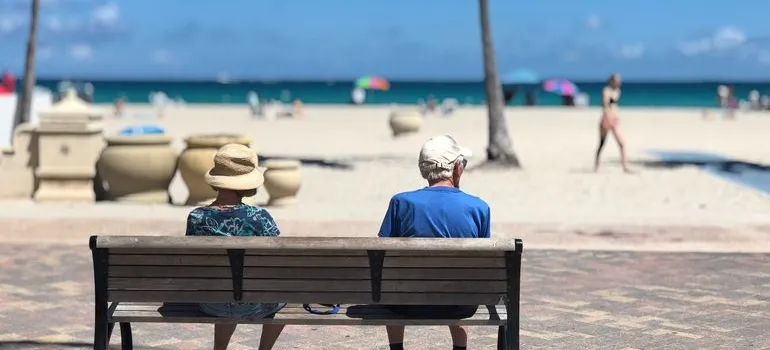 A couple sitting one the bench after retiring from DC to Miami