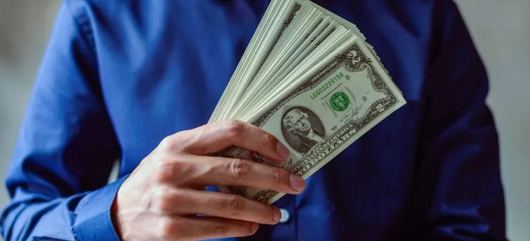 A person holding dollar bills 