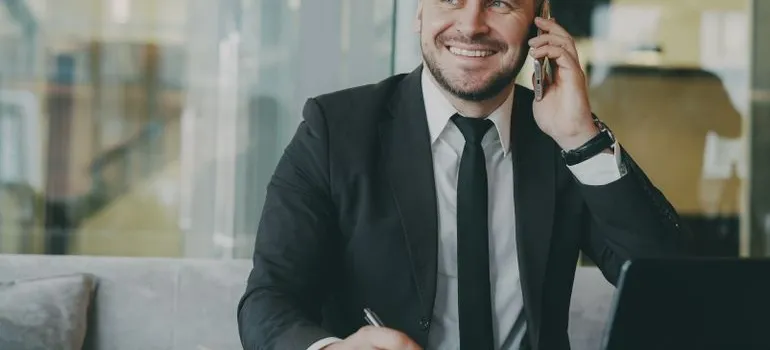A man in the office talking on the phone